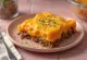 Auflauf mit Süßkartoffelpüree, Hackfleisch und überbackenem Käse